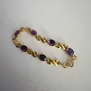 Gold bracelet with purple gems